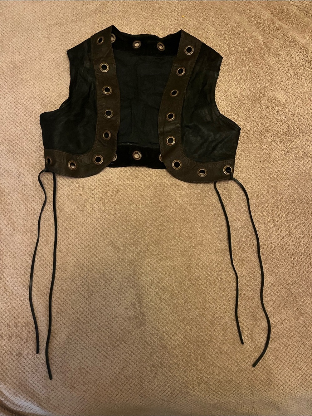 Short vest with grommets
